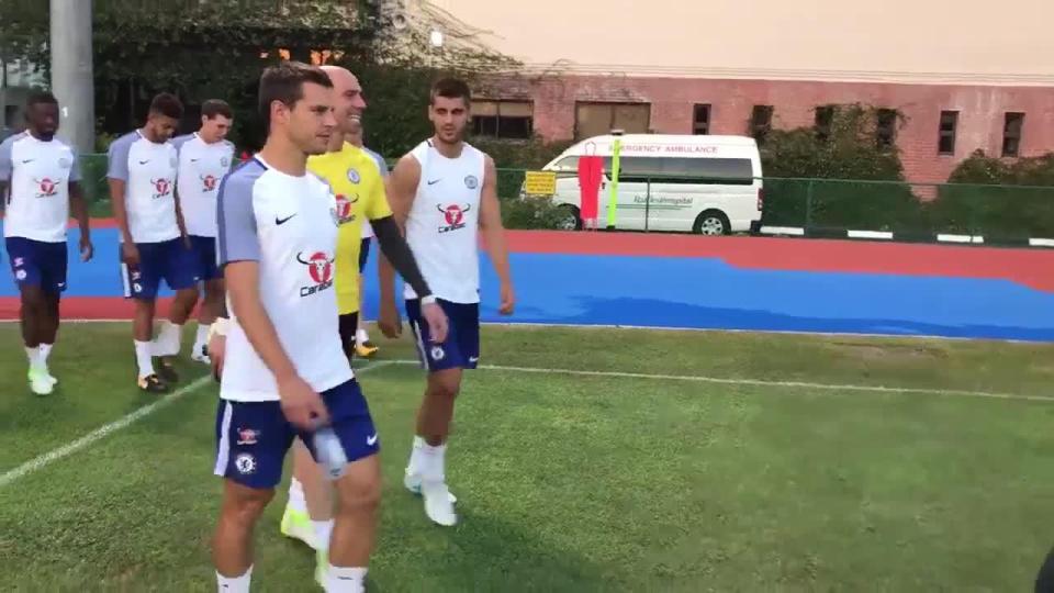 Morata chats to Willy Caballero and Cesar Azpilicueta as he walks out for training in Singapore