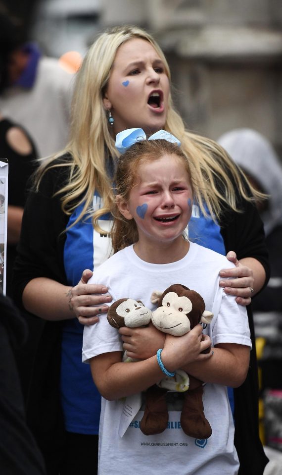  A young girl bursts into tears outside the court after the decision to end the legal battle was announced