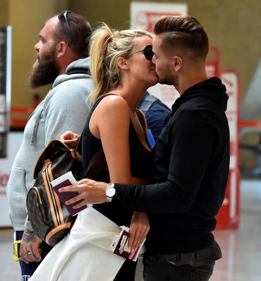  The couple were seen kissing as they waited for their flight