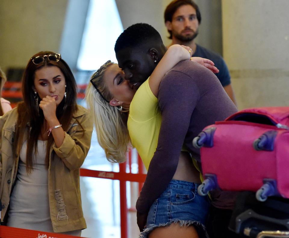  Gabby and Marcel looked loved-up in the queue in the terminal