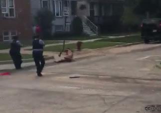  The nude man is floored on the street just opposite a school