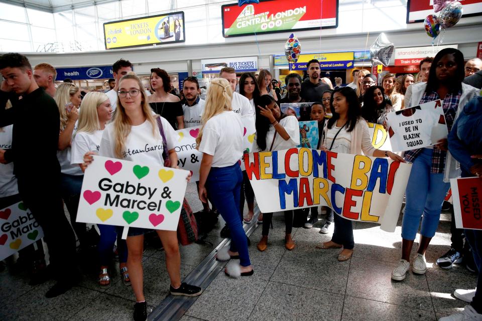  Gabby Allen and Marcel Somerville's loved ones teamed up to bring colourful posters to the airport