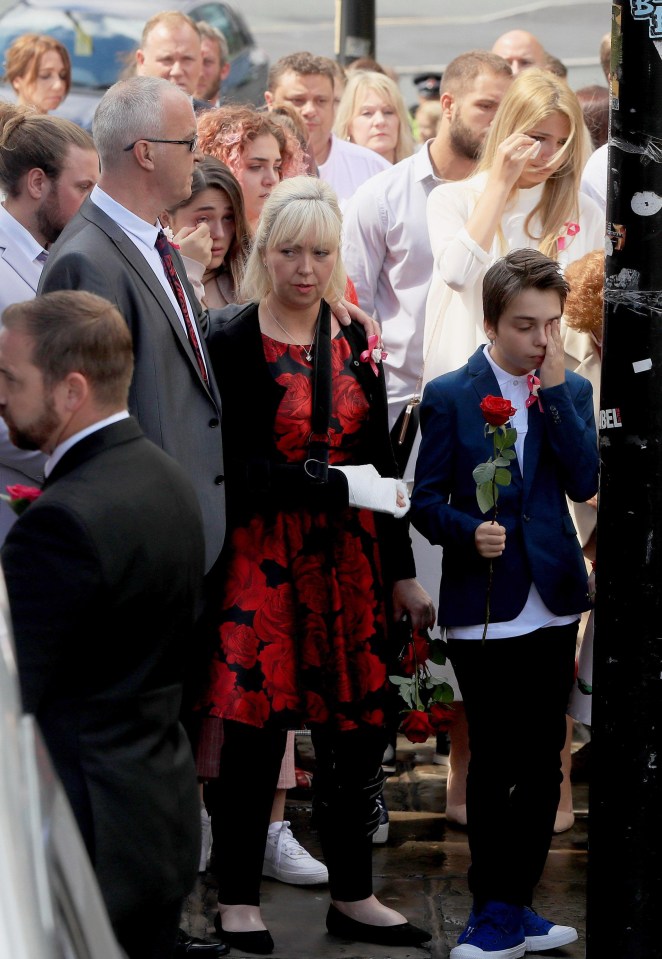 Saffie's brother Xander appeared to wipe away a tear from his eye as he followed his sister's wicker casket into the cathedral