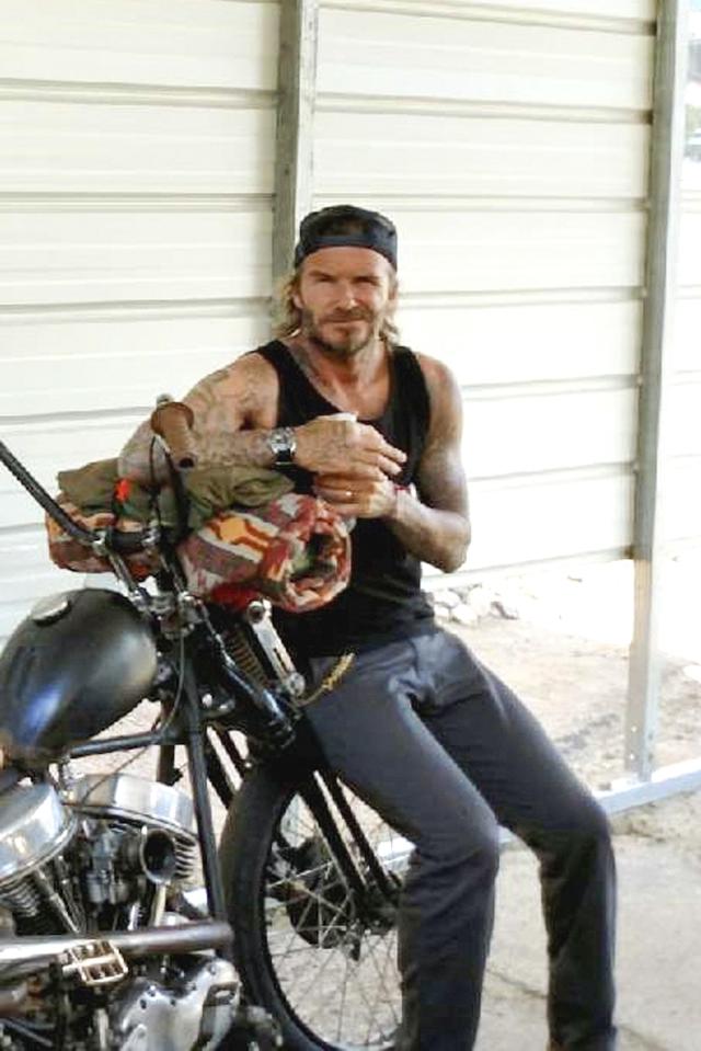  Looking typically cool, he wore a cap back to front and a black vest to show off his tattooed arms