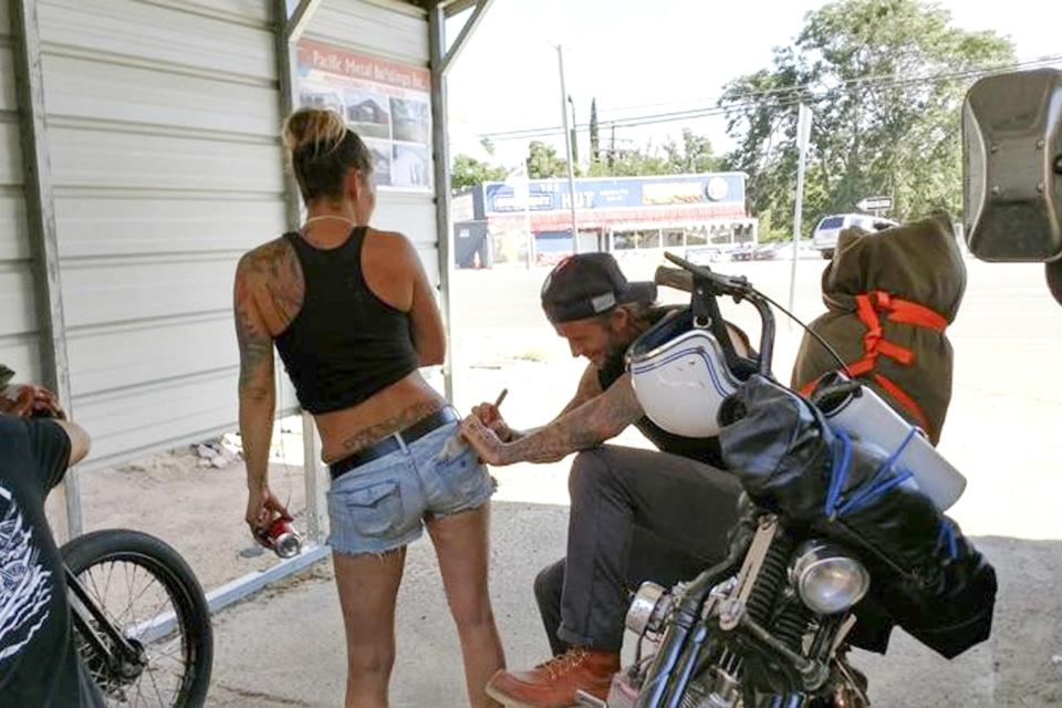  The footballing icon, 42, took a pit stop on his American motorcycle tour to squiggle his autograph on the denim hotpants of an inked admirer