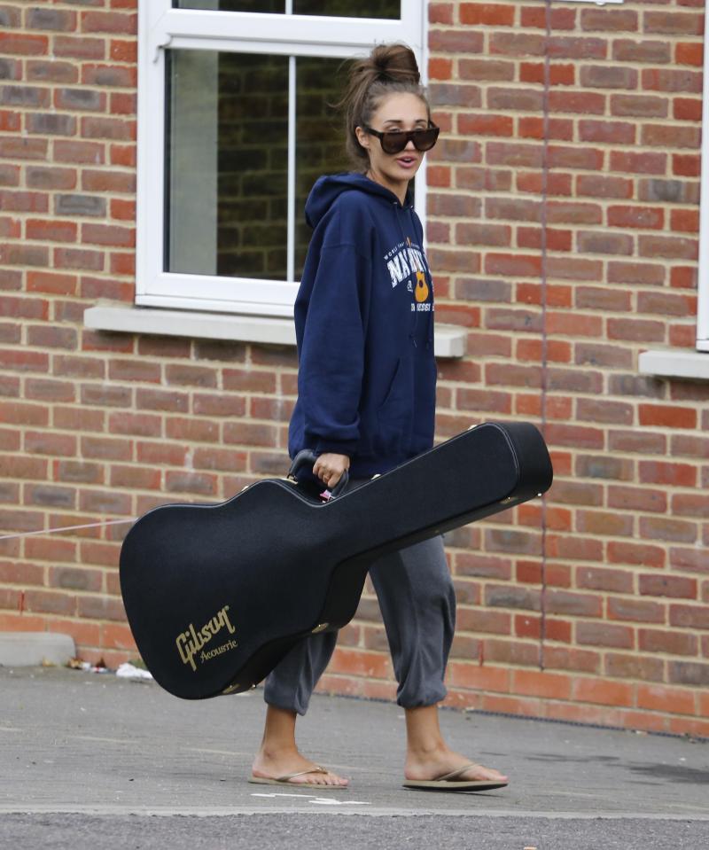  Megan was seen carrying her Gibson guitar into her flat