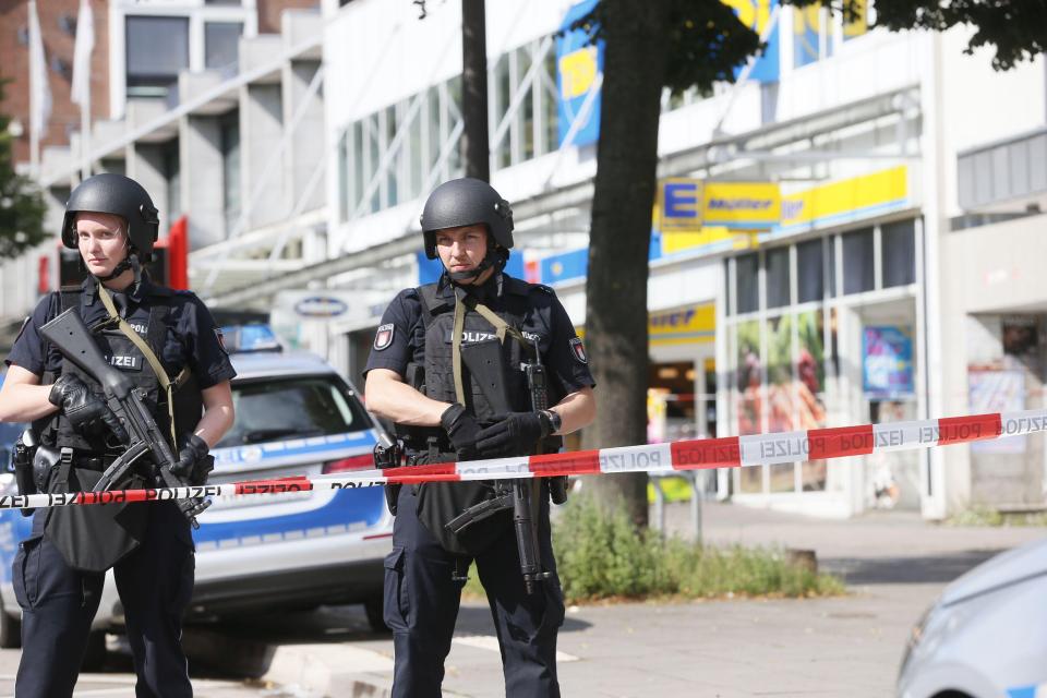  Armed cops stand guard at the scene of the deadly supermarket attack