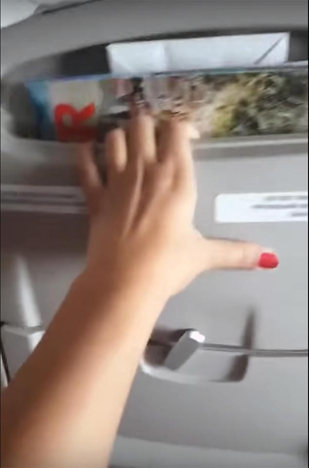  A woman's hand is seen gripping the seat in front during the terrifying descent