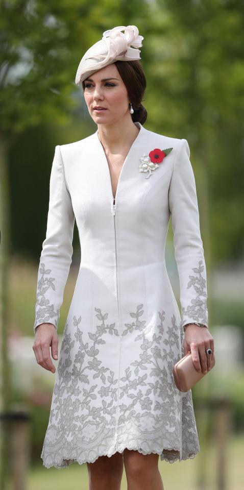  Kate's red poppy stands out against her cream long-sleeved dress and hat