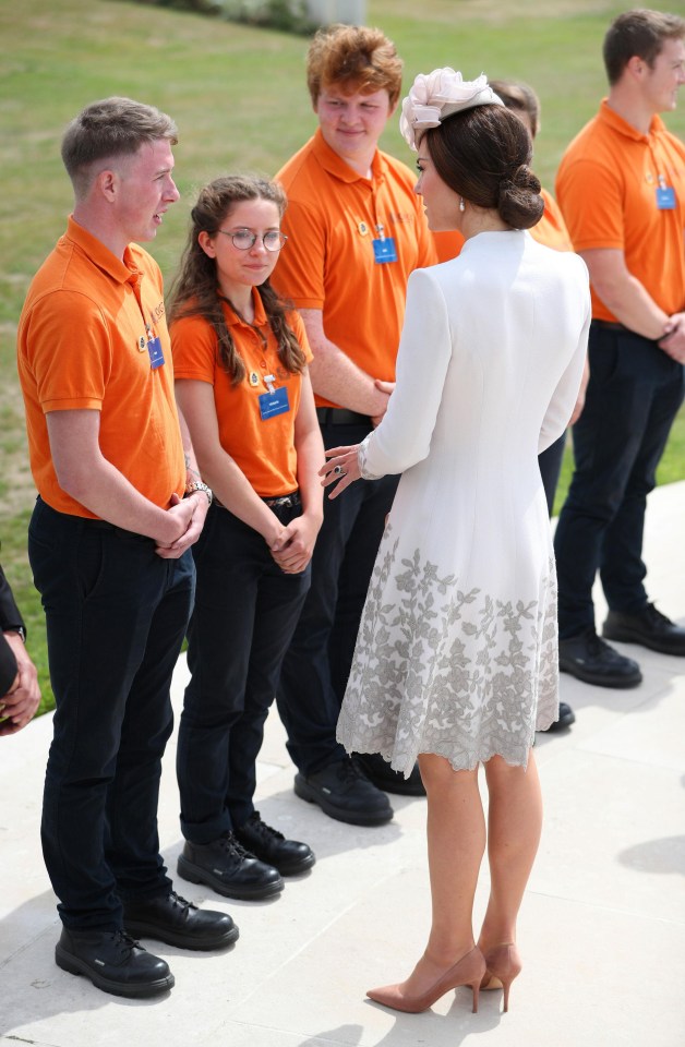 The Duchess of Cambridge speaks with workers at the cemetery, where more than 5,000 servicemen from the First World War are buried