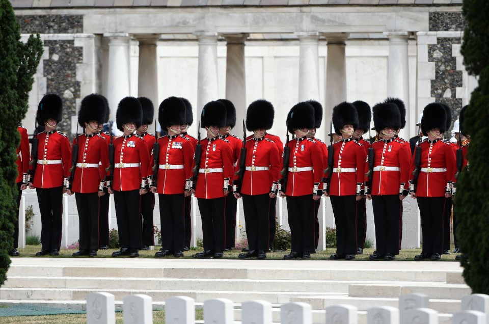 The 1st Battalion of the Irish Guards stand to attention at the cemetery, where more than 11,000 soldiers are buried