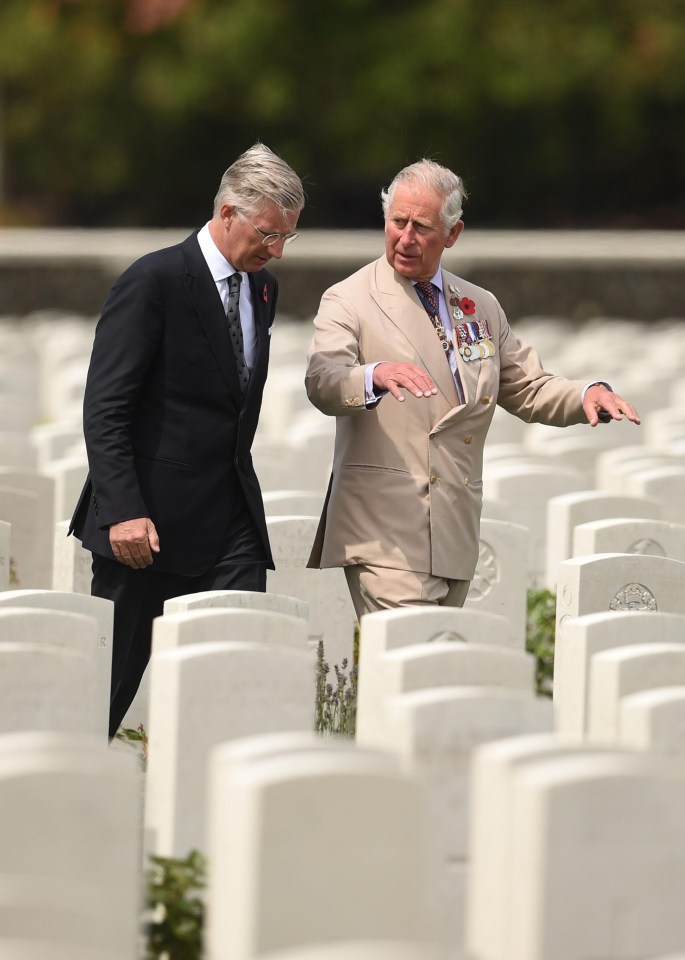 Prince Charles talks to King Philippe of Belgium as they walk through graves in Tyne Cot today