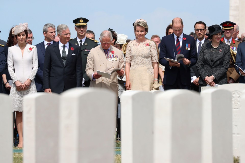 Kate, King Philippe, Prince Charles, Queen Mathilde, Prince William and Theresa May line up at the graveside at Tyne Cot cemetery today