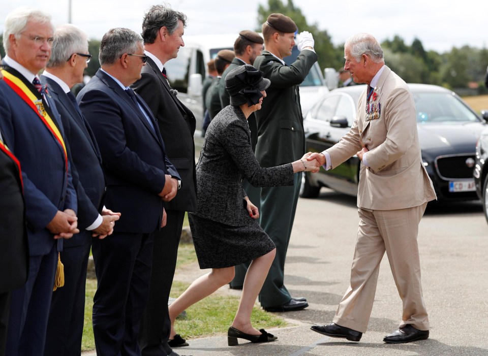 Theresa May bows to Prince Charles during the event in Ypres