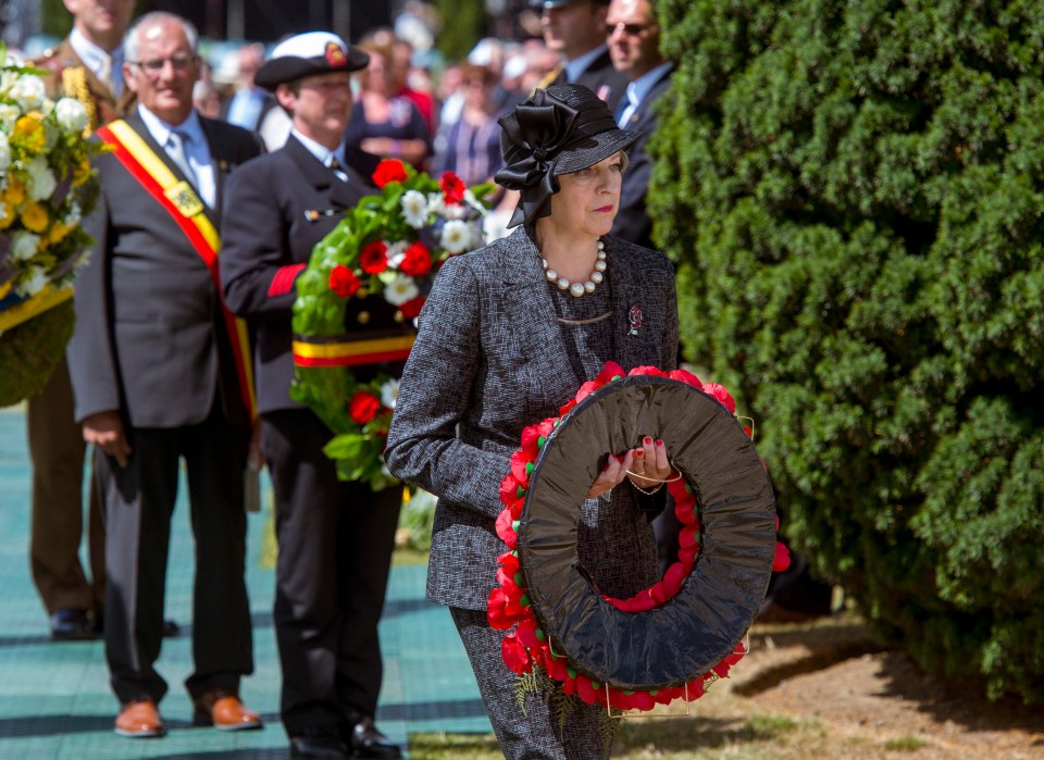 Theresa May carries a wreath to lay on the Stone of Remembrance at Tyne Cot cemetery