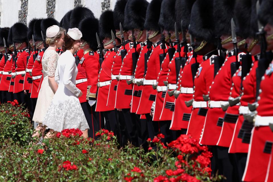  Kate and Queen Mathilde walk towards a row of Irish Guards at Tyne Cot today