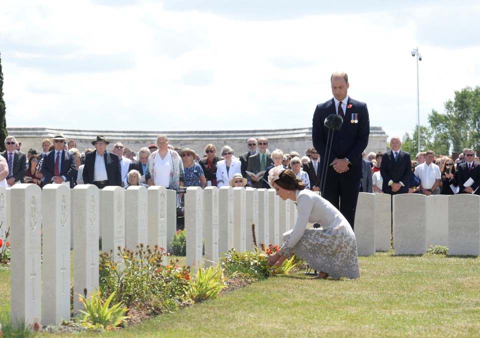 Kate tends a grave at Tyne Cot cemetery as William watches on