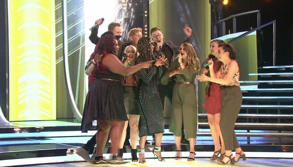  The group celebrated with the singer as they were announced as winners