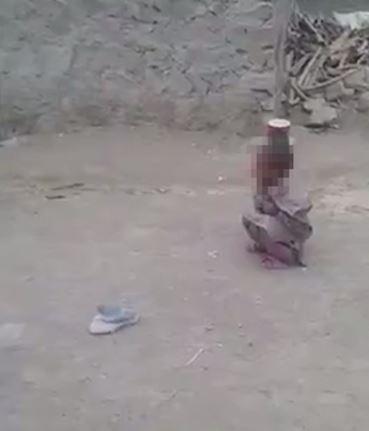  Just a few feet to his right, an even younger child crouches with a tin can resting on his head