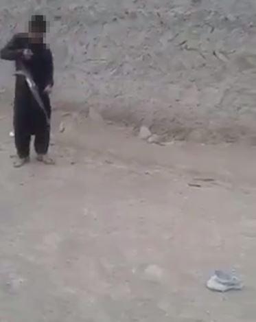  The short video first shows a young boy clutching a gun