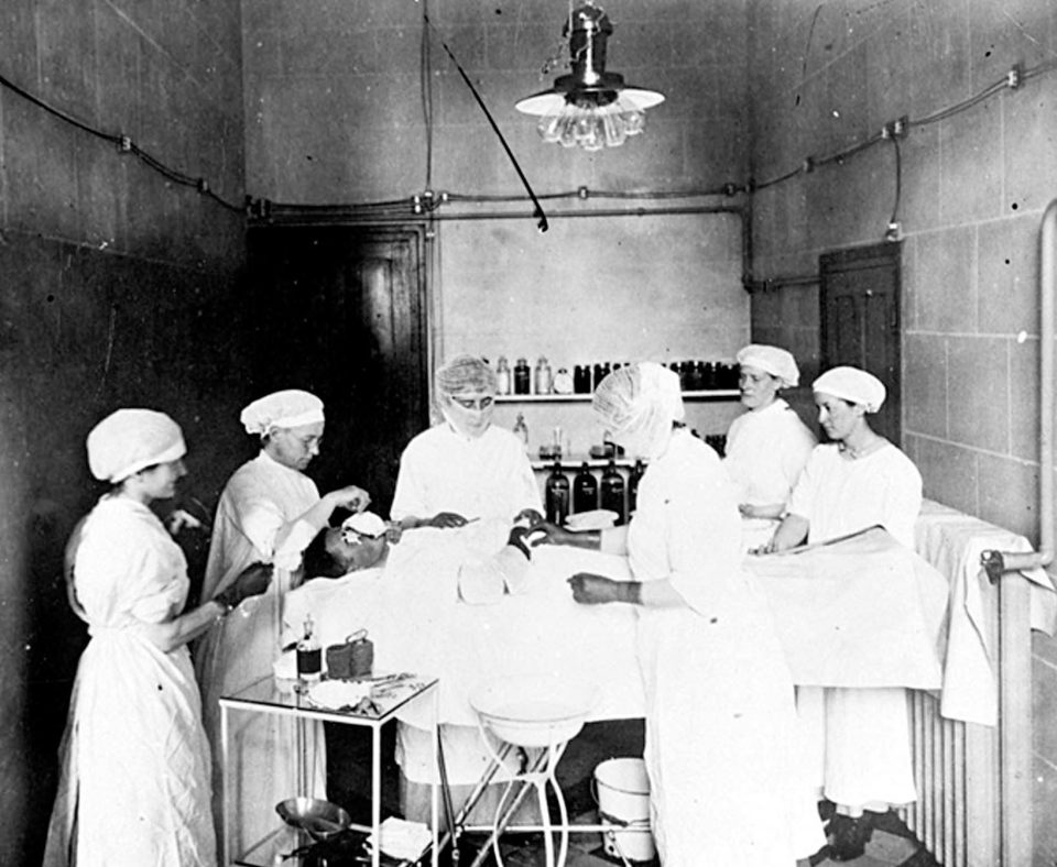  Members of the Scottish Women's Hospital Unit performing an operation at their hospital in Royaumount Abbey, France