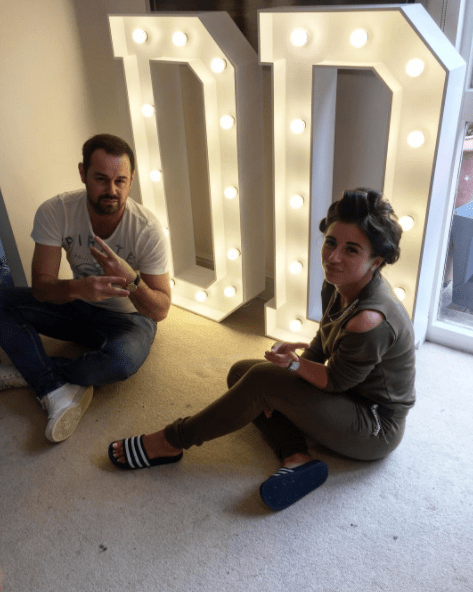  Before her party, she posed with dad Danny and her light up initials