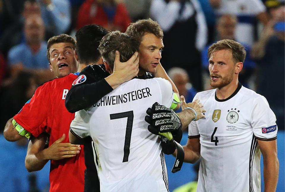  The defender celebrates an international win against Italy with Bastian Schweinsteiger and Manuel Neuer