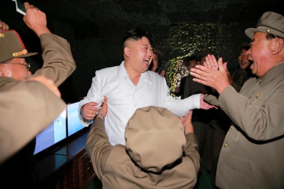  Kim Jong-un reacts as he inspects a test-fire of strategic submarine-launched ballistic missile with Ri Pyong Chol