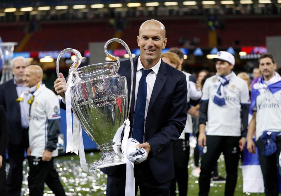  Zinedine Zidane proudly shows off his spoils after leading Real to back-to-back Champions League wins