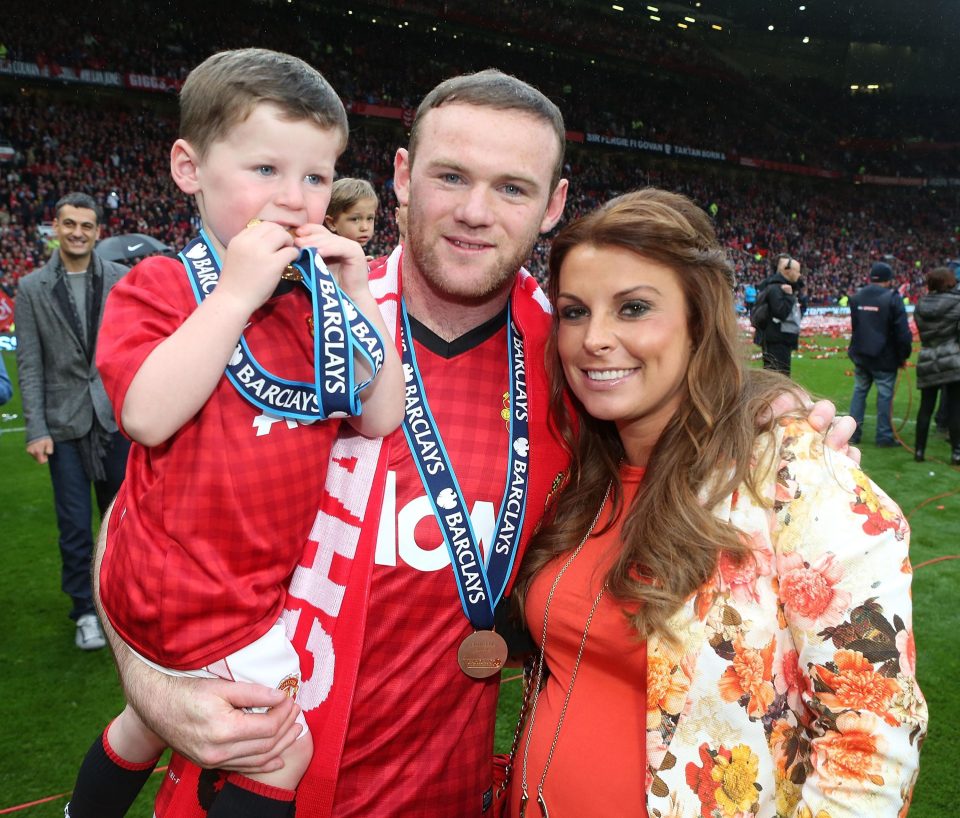  Wayne and Coleen with their son Kai on the pitch with Manchester United