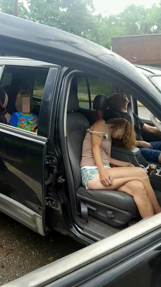 Rhonda Pasek and a male companion lie passed out as a four-year-old child sits in the back