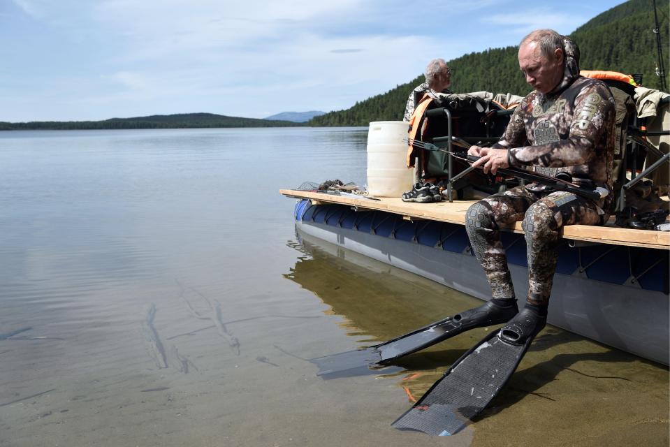  Deep cover...the President wears flippers and kit for lake dip