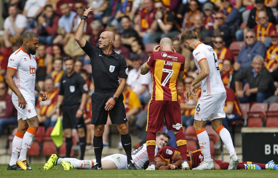  The referee signals for treatment to come onto the pitch immediately following the accidental clash of heads