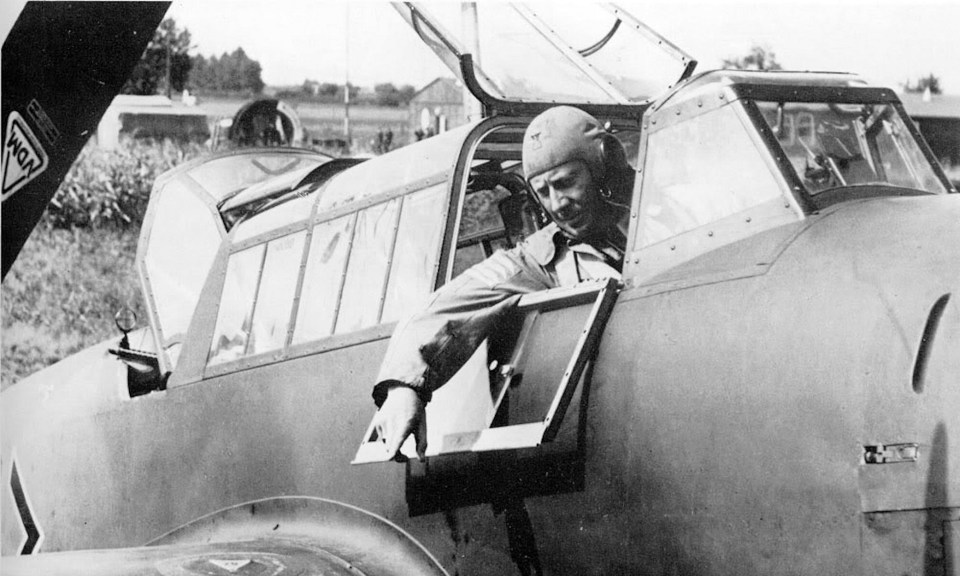 A fighter pilot leans out of his cockpit window during the fighting in 1940