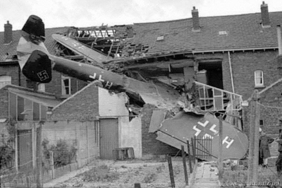 A downed Nazi plane is pictured here embedded in a house during the Battle of Britain