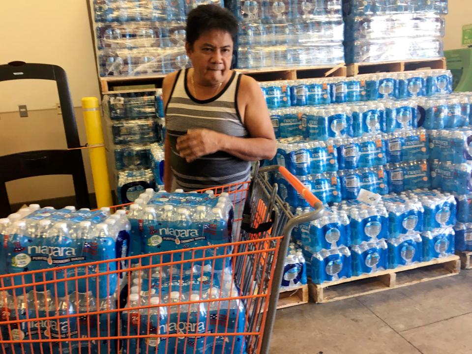  One worried local fills his trolley to the brim with bottled water