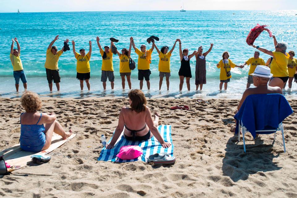  Protesters formed a human chain across a beach in Barcelona