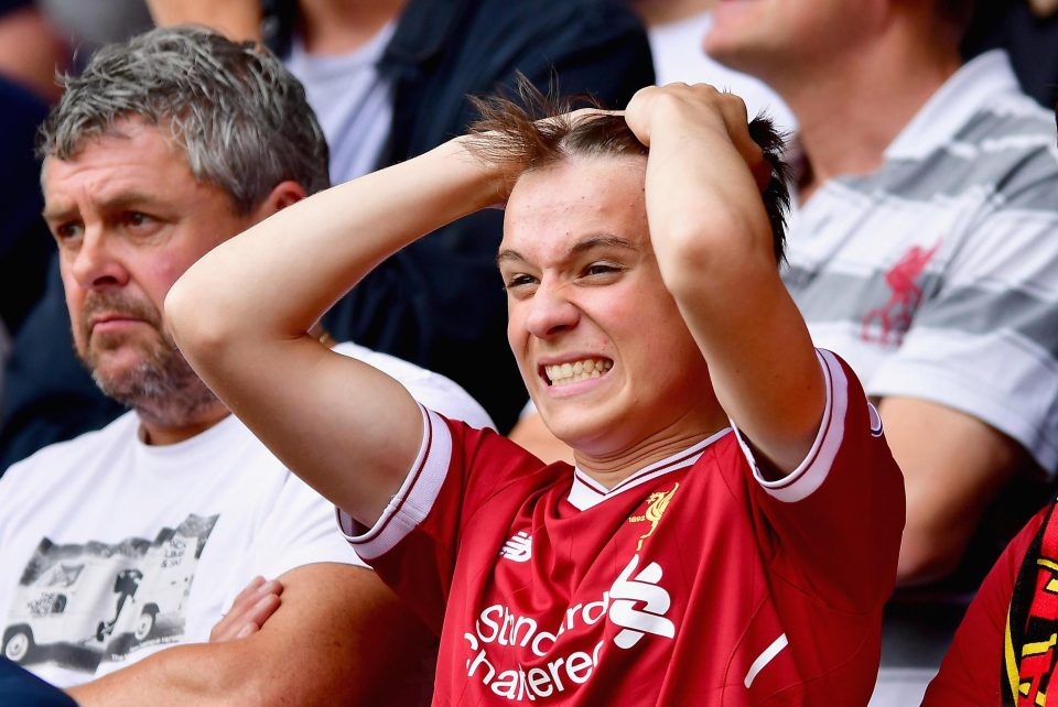  A Liverpool fan reacts after conceding a last minute equaliser