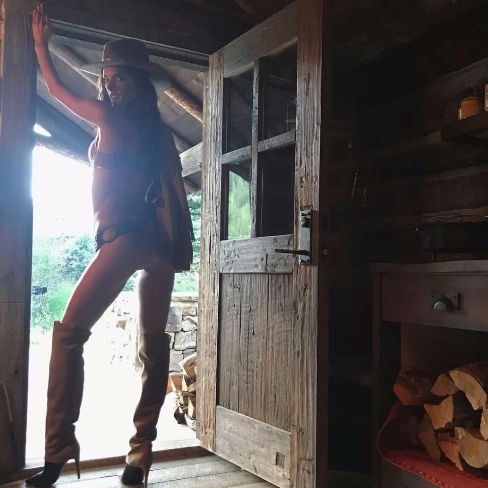  Alessandra Ambrosio posed in high heeled cowboy boots in another sizzling shot