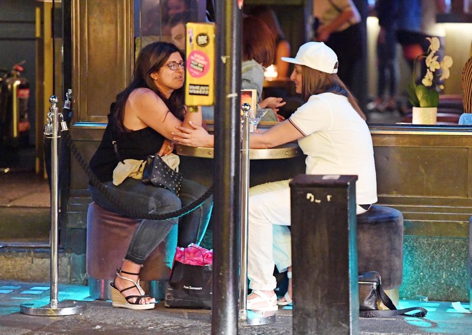  They stroked each other's arms as they enjoyed cocktails