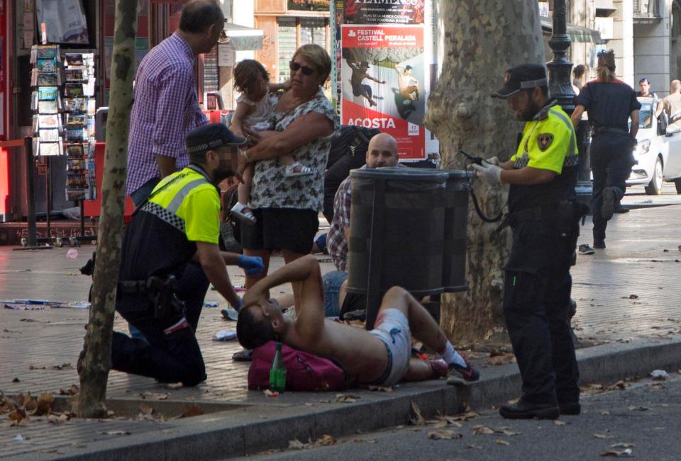  Emergency services tend to an injured man. 80 people were hospitalised