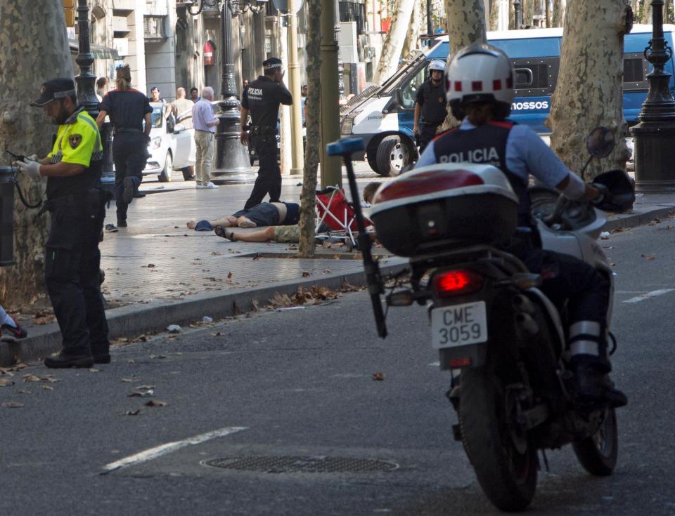  Bodies are pictured lying on the ground in the Las Ramblas area