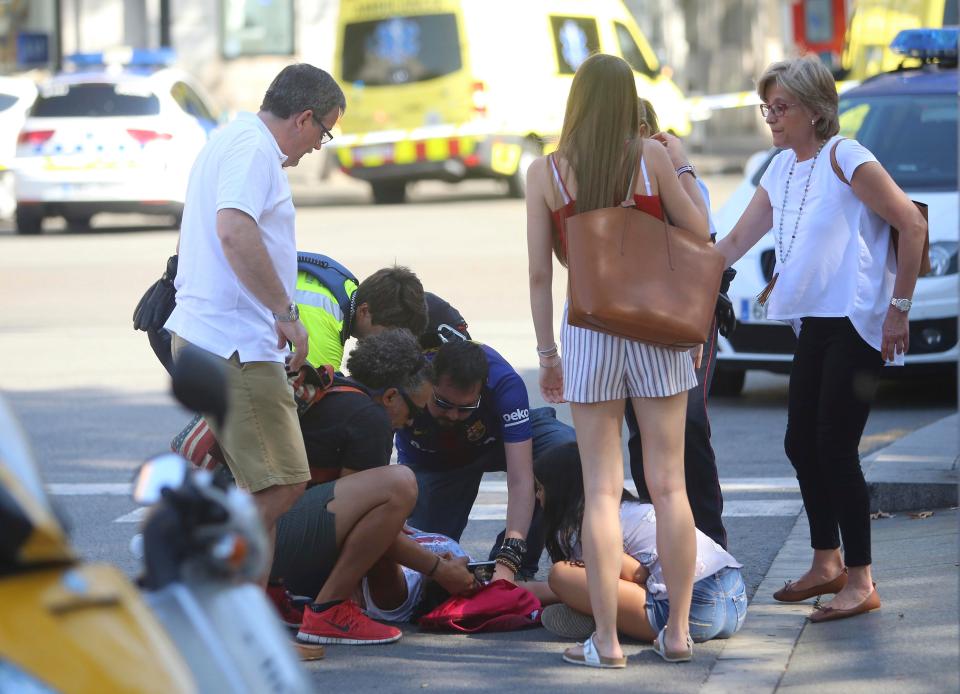  Witnesses work to tend to the injured in the aftermath of the van horror