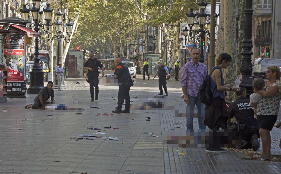  Bodies lay across Las Ramblas - a popular tourist spot in Barcelona - after the brutal van attack