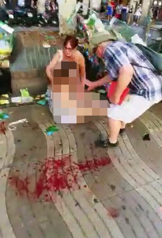  Another victim is pictured in the shopping district with blood splattered on the ground