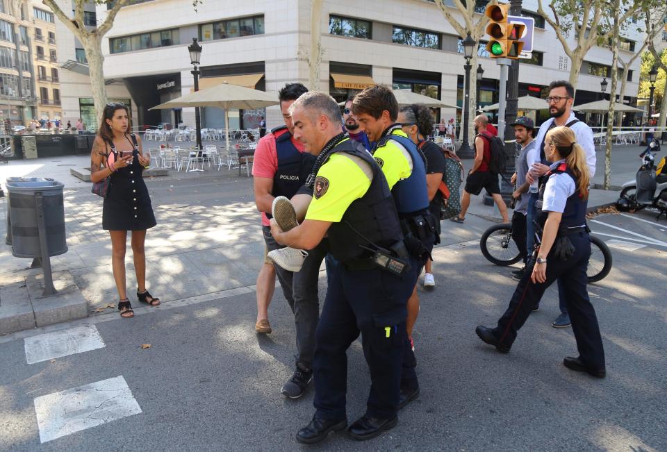  An injured victim is carried away by emergency workers