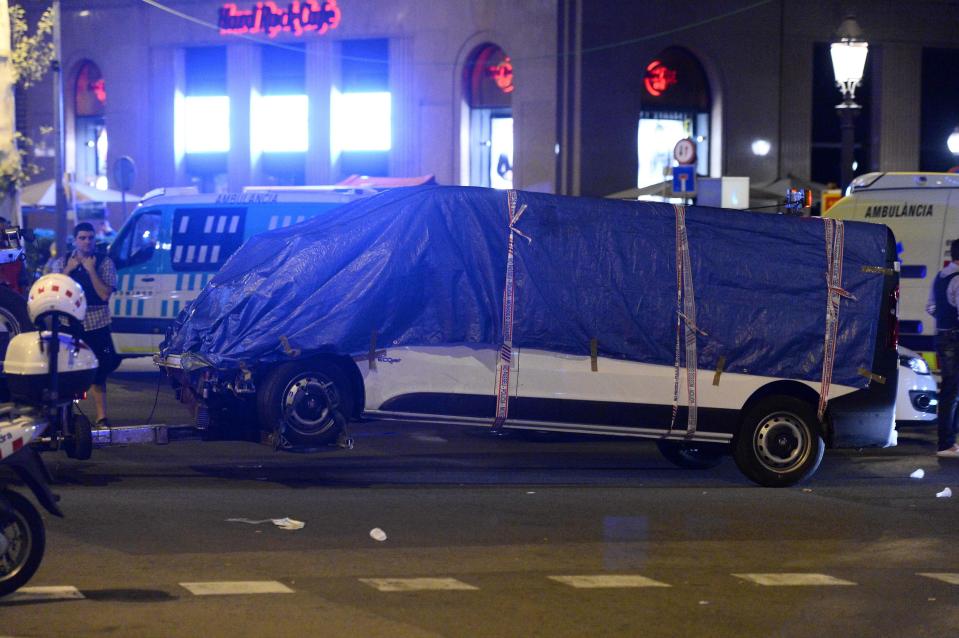  The white rented van used as a weapon in the terror attack is towed away by authorities