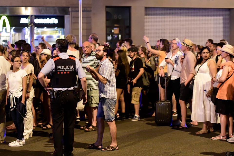  Holidaymakers in Barcelona wait outside their hotel, which has been placed in lockdown, in Las Ramblas