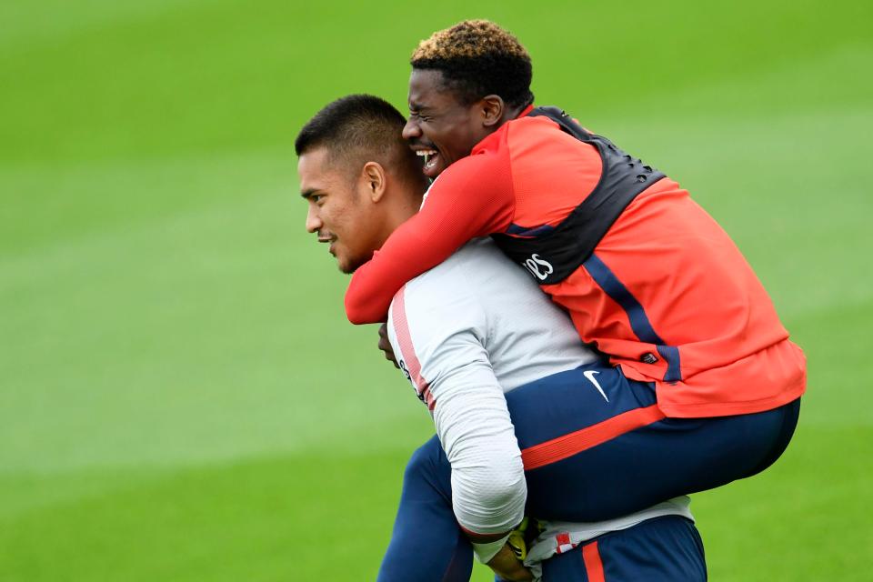  Aurier hitches a ride from keeper Alphonse Areola at training last Friday