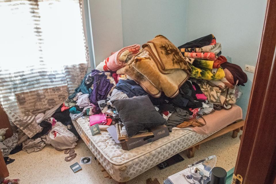  A heap of cushions and blankets can be seen on the bed